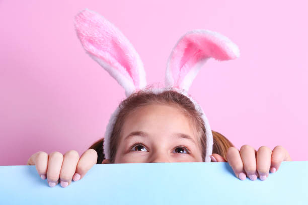 istock Conceptual image with a girl wearing bunny ears for easter celebration. 1218430172