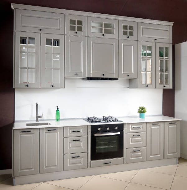istock Interior of white and grey kitchen, horizontal. Luxury modern fitted flat design kitchen with glass elements. 1218430434