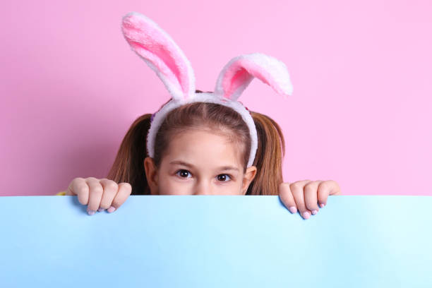 istock Conceptual image with a girl wearing bunny ears for easter celebration. 1218431208