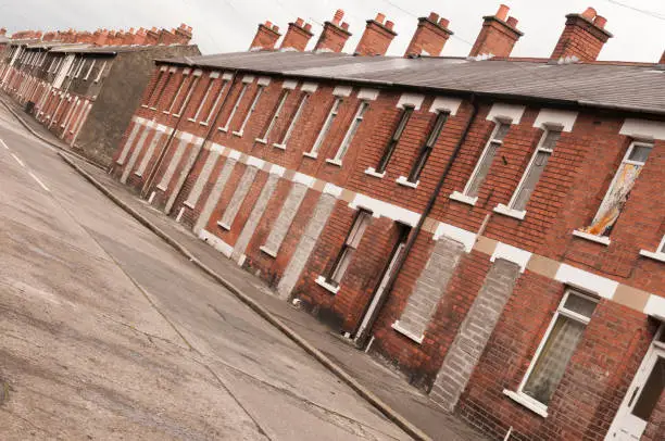 Bricked up and abandoned town houses in a run-down inner-city street in Belfast