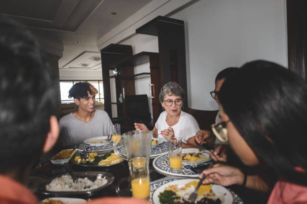 istock Family having lunch at dining table served with feijoada, typical brazilian black bean stew 1218431433