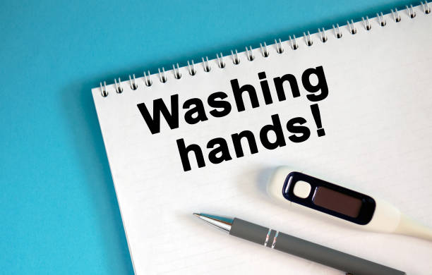 istock Washing hands - text on a notepad. Lie a pen and a medical thermometer 1218432494