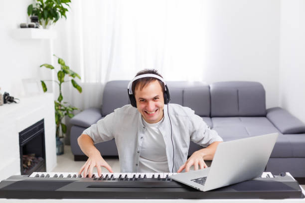 istock Man playing music with piano and laptop 1218434155