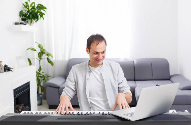istock Man playing music with piano and laptop 1218434193