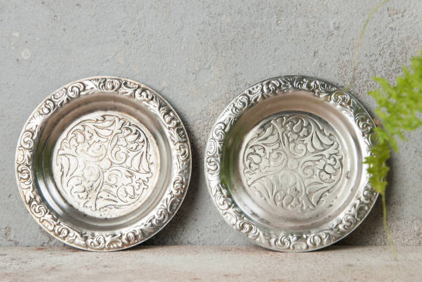 istock Old metal coasters, small dish on concrete background. 1218434326