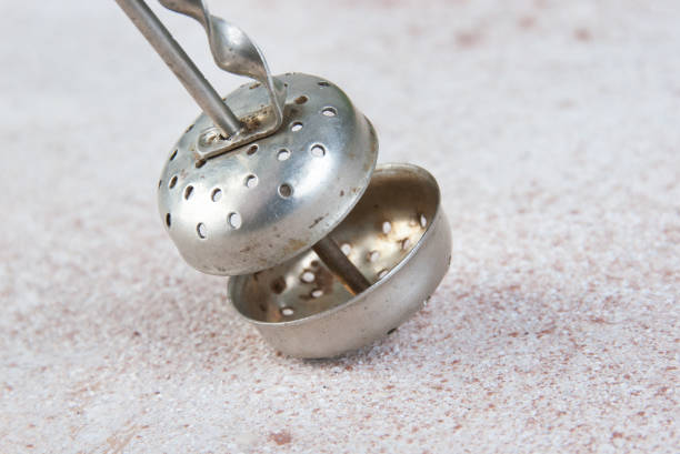Old tea strainer on concrete background.