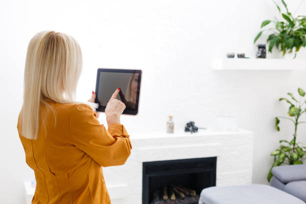 istock Elegant young businesswoman using tablet, looking at screen 1218435275