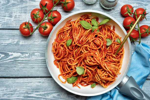 istock Delicious pasta with tomato sauce on blue background 1218437466