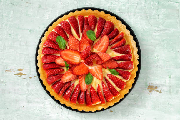 istock Top view of strawberry flan cake on light mint background 1218438002