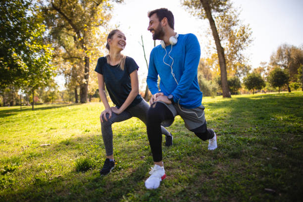 Athletic couple stretching outdoors in the park