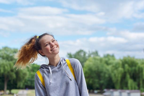 closeup portrait of teenage girl of 14, 15 years old in gray sweatshirt - 13 14 years teenager school education imagens e fotografias de stock