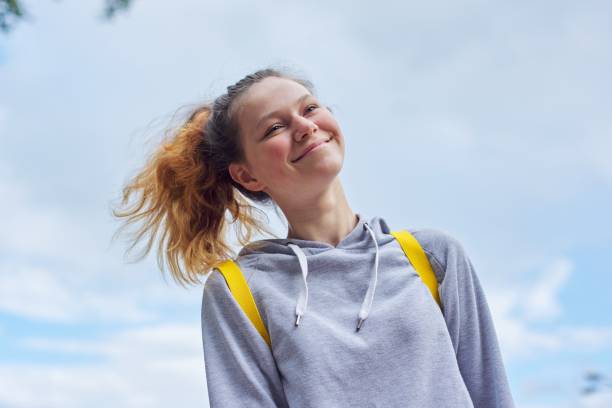 portrait of teenage girl 15 years old, smiling pretty girl in gray sweatshirt - teenager 14 15 years 13 14 years cheerful imagens e fotografias de stock