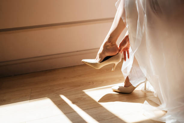 istock Bride taking off her shoes after wedding, romantic concept with copy space 1218440832