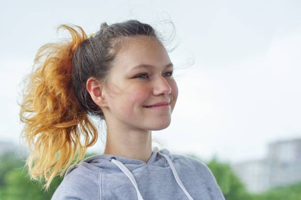 closeup portrait of teenage girl of 14, 15 years old in gray sweatshirt - 13 14 years teenager school education imagens e fotografias de stock