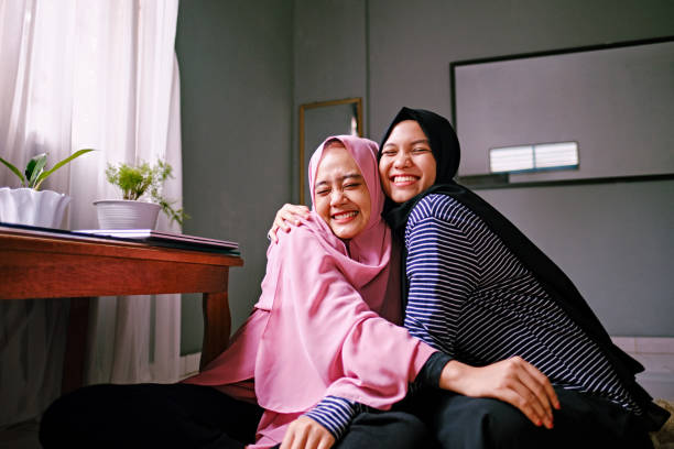 istock Two Happy Indonesian Women Hugging Together - Looking camera 1218443354