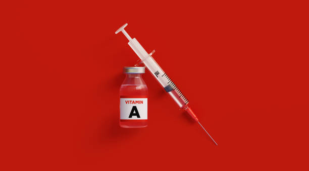 istock Injectable A Vitamin  and Syringe on Red Background 1218443553