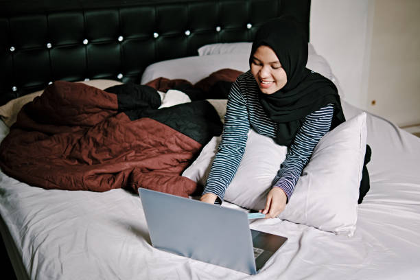 istock Beautiful Hijab Women Work From Home on Bed 1218443847