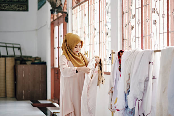 istock Islam Women Finishing Praying at Mosque 1218444519
