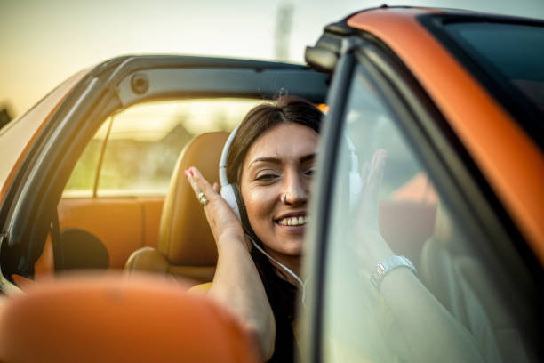 istock Young woman having fun in her convertible 1218445935