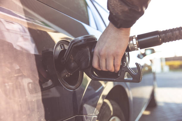 istock refueling a passenger car tank at a gas station. Blurred 1218449868