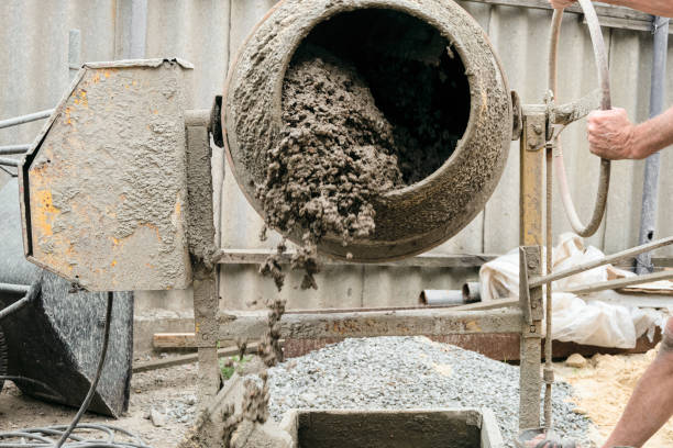 Concrete spills out of the tank. Concrete mixer in blurry motion mixes expanded clay with cement. Concrete spills out of the tank. Concrete mixer in blurry motion mixes expanded clay with cement. mixing vat stock pictures, royalty-free photos & images