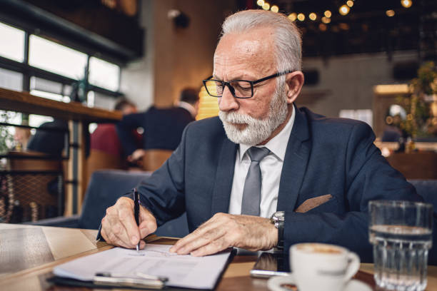 istock Senior business writing for work at a cafe 1218451310