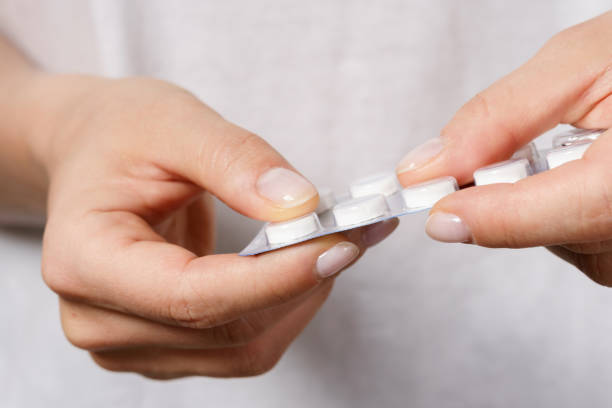 istock Female hand with a pill in foil packaging 1218451326