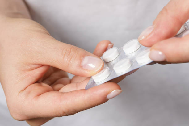 istock Female hand with a pill in foil packaging 1218451331