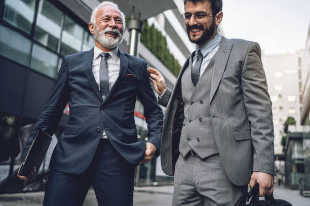 Cheerful father and son businessmen returning from work together
