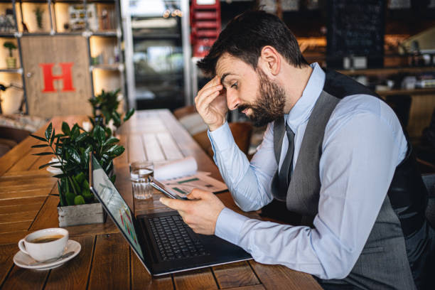 istock Frustrated and overworked young businessman at a cafe 1218451929