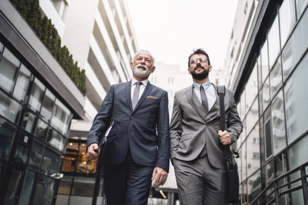 istock Motivated business partners walking in downtown district 1218452036