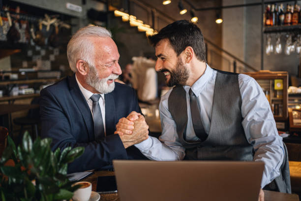 istock Successful businessmen handshaking in agreement at a cafe 1218452269