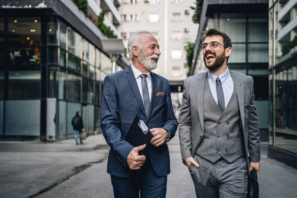 istock Carefree business colleagues laughing while returning from work 1218452819