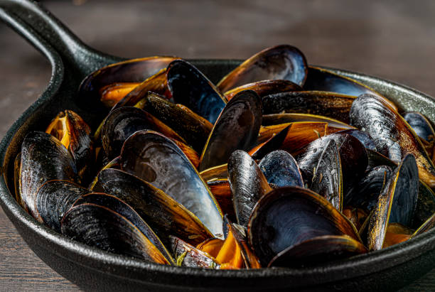istock Steamed mussels in cast iron pot. 1218454266