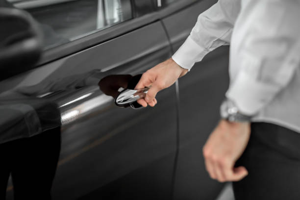 istock male hand holds a black car door handle 1218455269