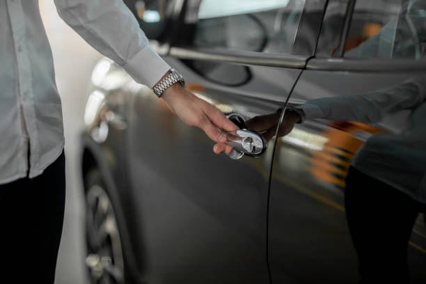 istock male hand holds a black car door handle 1218455285