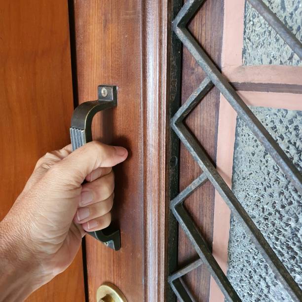 istock Hand touching door knob 1218456147