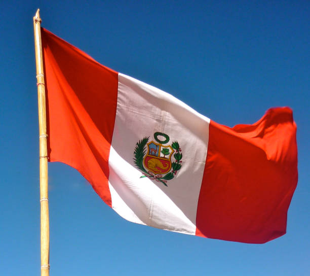 istock The Peruvian national flag against a blue sky 1218457126