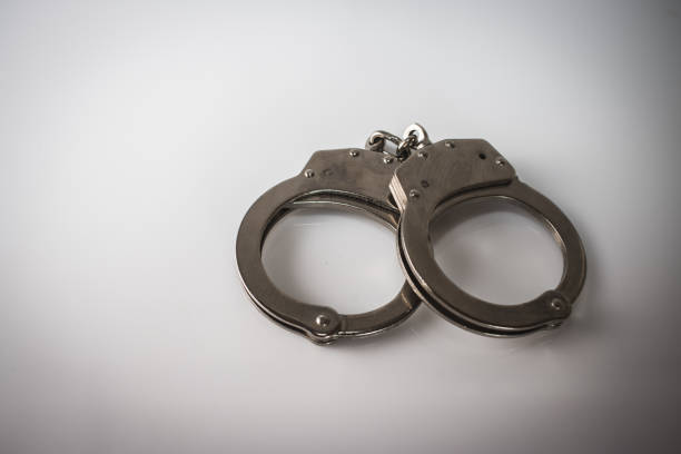 istock steel metal Handcuffs on  white background isolate 1218463091