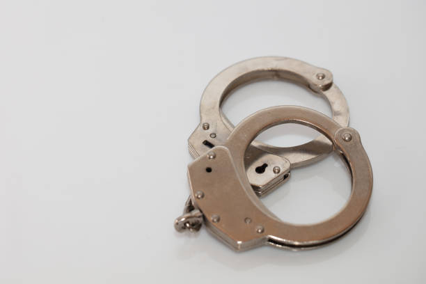 istock steel metal Handcuffs on  white background isolate 1218463097