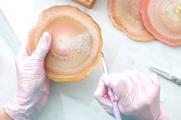 istock Creativity and craft. A young girl creates coasters from resin. Gift wrapping. Decorative packaging. Idea for business. Remote work, work at home. Art coasters. 1218464253