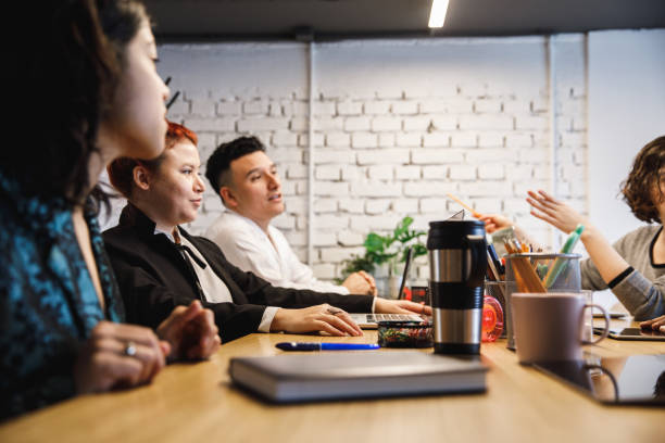 istock Group of multi-ethnic business partners having a brainstorming session 1218464302