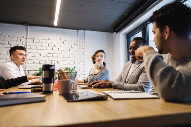 istock Group of diverse office colleagues having a brainstorming session 1218464305