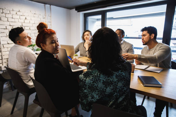 istock Group of multi-ethnic office colleagues having a brainstorming session 1218464307