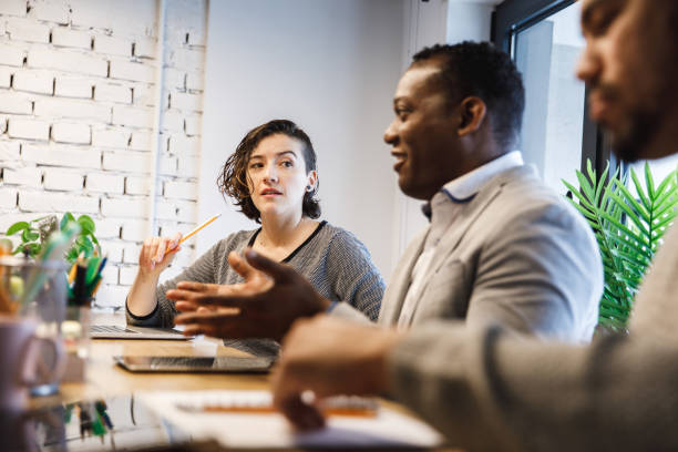 istock Group of diverse business partners having a brainstorming session 1218464316