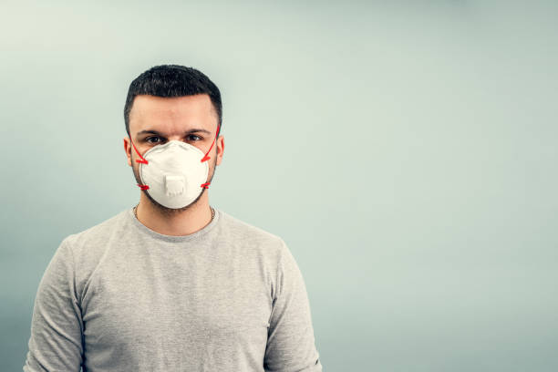 istock A man is putting on a protective mask. Respiratory protection from coronavirus. Personal protective equipment for a pandemic of a viral infection. Covid-19. 1218464444