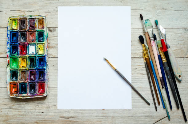 istock Artist paint brushes on the wooden background 1218465531