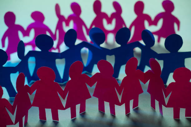 istock Paper dolls holding hands symbolizing union and team 1218467220