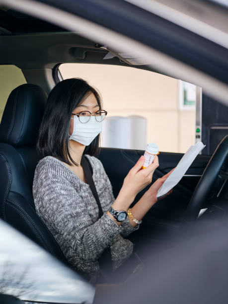 istock Woman Wearing Mask at Drive-Through Pharmacy 1218468081