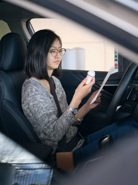 istock Woman at Drive-Through Pharmacy 1218468092